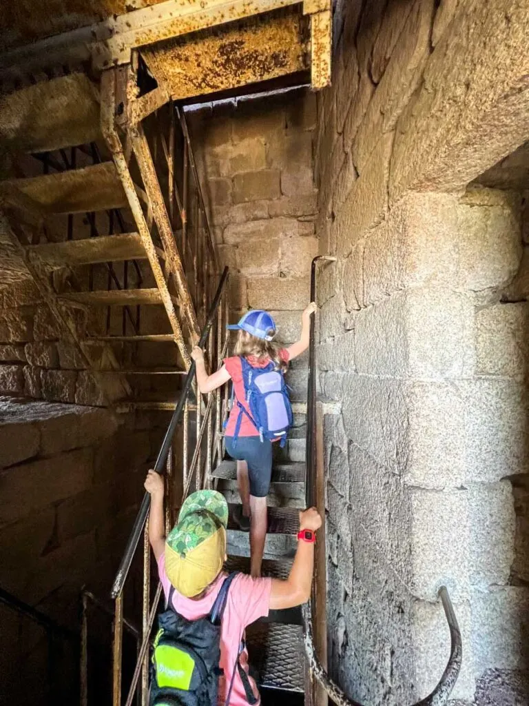 two kids exploring the ruins of Bernstein Castle in the Alsace wine region of France