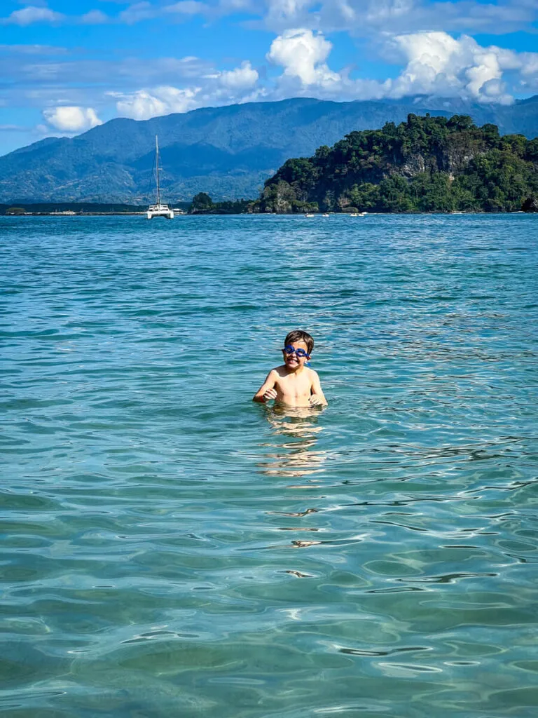 a 7-year old boy plays in the water at the family-friendly Biesanz Beach in Costa Rica