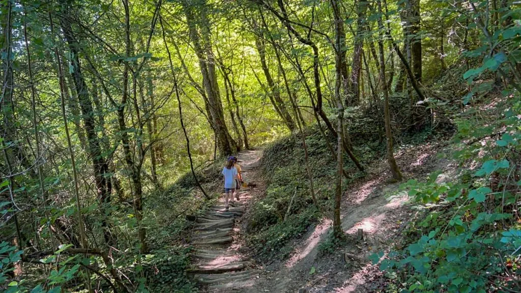 two kids enjoy a forest hike near the Gorges du Fier attraction near Annecy, France
