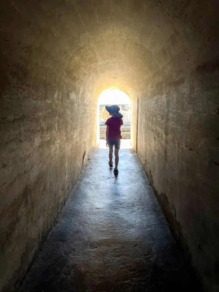 a girl walks through a tunnel at Castillo San Cristobal fort in San Juan, Puerto Rico.