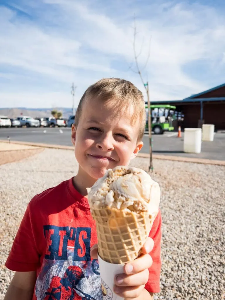 a young boy holds an ice cream waffle cone at PistachioLand in Alamogordo, New Mexico.
