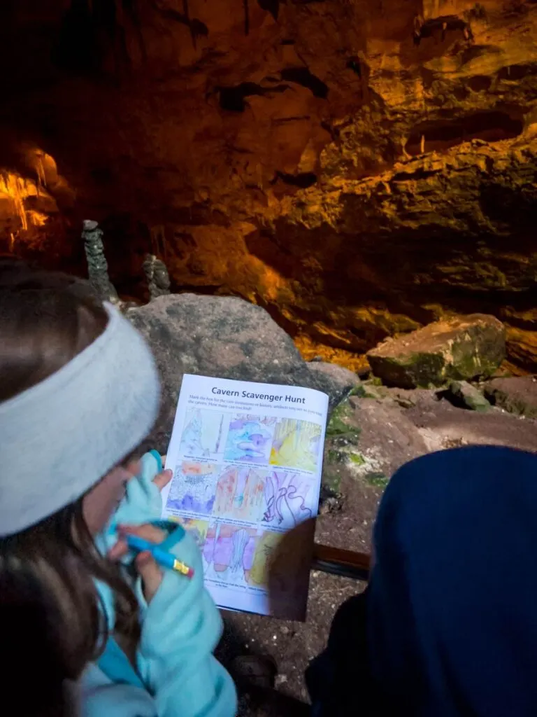 Two kids work on the scavenger hunt as part of their Junior Ranger program at Carlsbad Caverns.