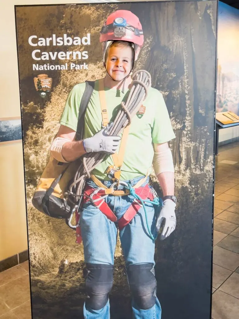 a young boy poses with a fun cardboard cutout at Carlsbad Caverns, New Mexico.