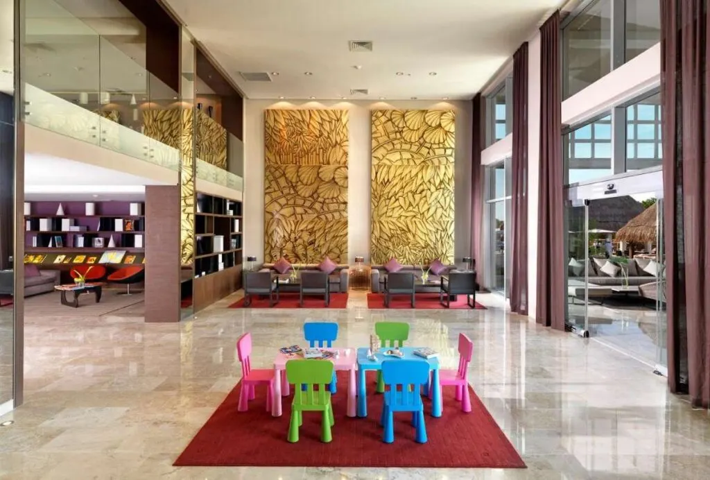 a colorful kids table sits in the elegant lobby of the Paradisus Playa del Carmen La Esmeralda resort.