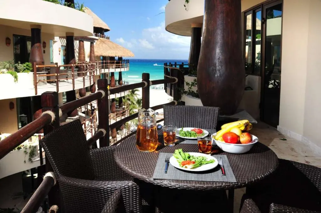 a table filled with fresh fruit on a balcony facing the Caribbean Sea at the El Taj condo.