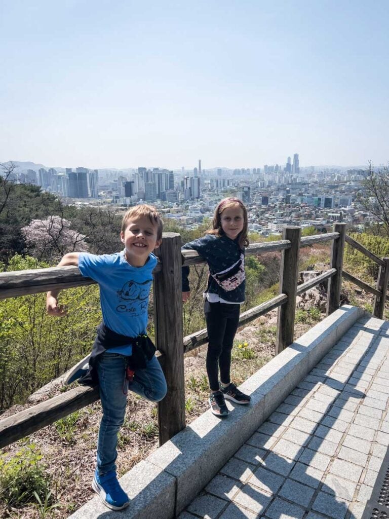 two kids enjoy a family hikes in Namsan Mountain Park in Seoul, Korea.