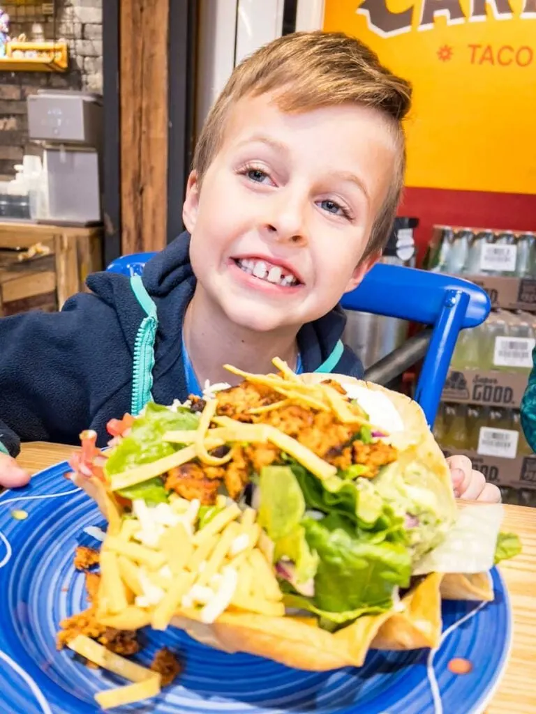 a young boy and his taco salad at a kid-friendly restaurant in Seoul.