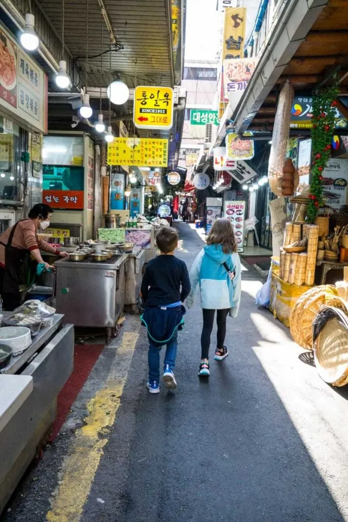 two kids explore the Namdaemun Market during a family vacation to Seoul, Korea.