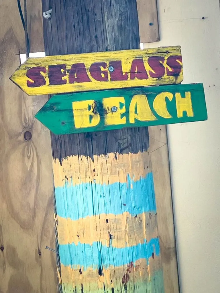 a colorful sign for Sea Glass Beach Vieques.