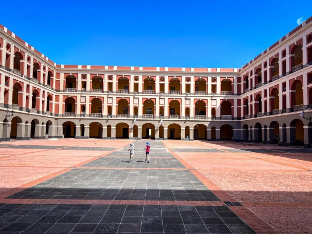two kids have fun in the courtyard in front of the Museo de las Américas in San Juan.