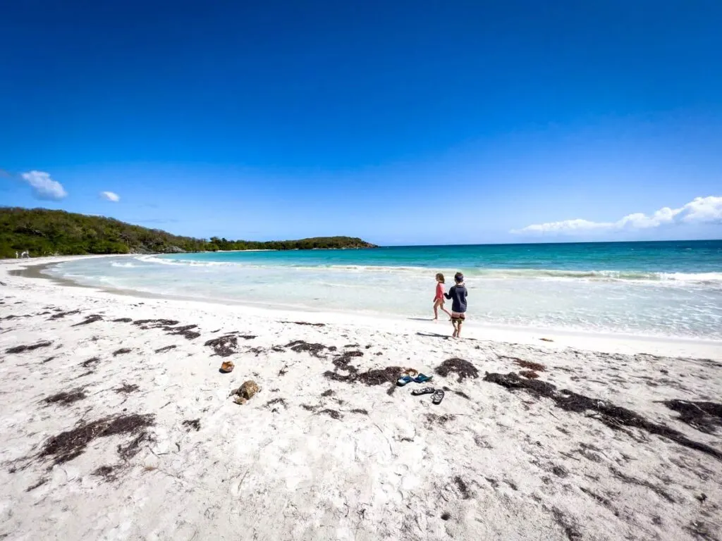two kids play in the sand along one of the most beautiful beaches in Vieques, Puerto Rico.