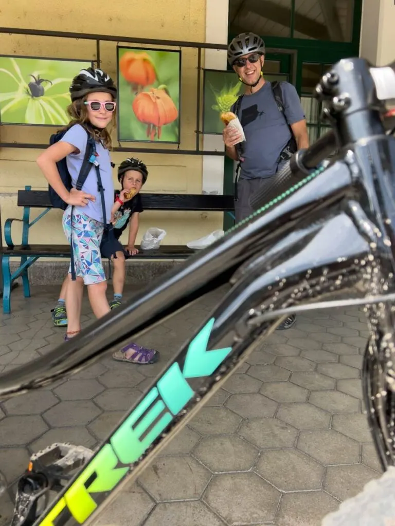 a family on a self-guided cycling tour waits for a train.