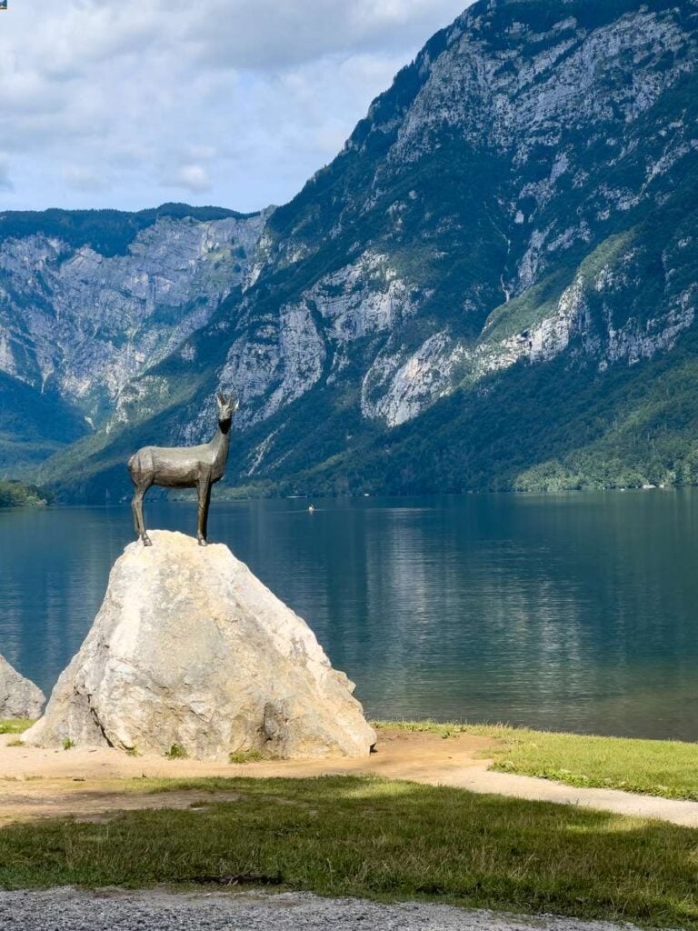 an ibex statue on the shores of Lake Bohinj.