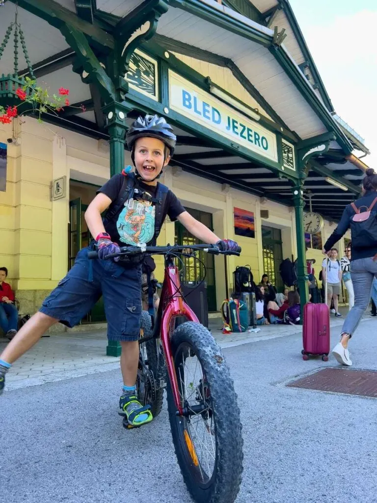 a boy enjoys himself while waiting for a train at the Bled-Jezero train station.