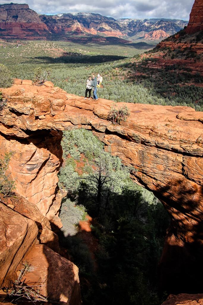 Dan Brewer and Celine Brewer, from the Family Can Travel team pose for a picture with their kids on a hike near Sedona, Arizona.