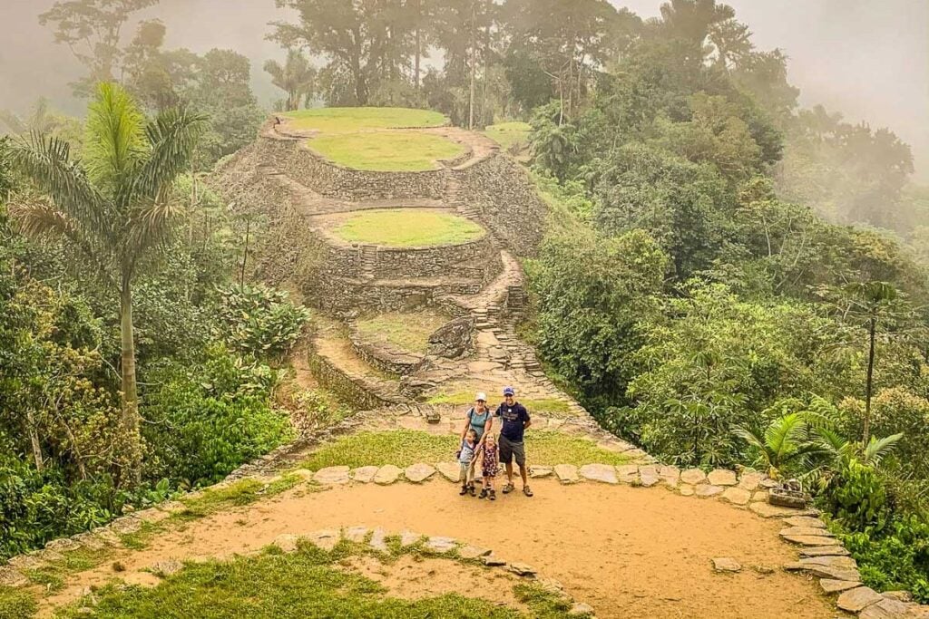 The Brewer family standing on ancient stone terraces at Ciudad Perdida in Colombia.