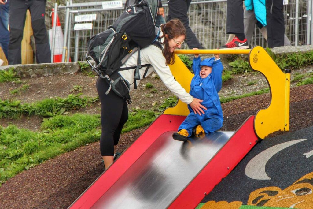 Celine Brewer plays with her son at a Bergen playground on top of Mt. Fløyen.