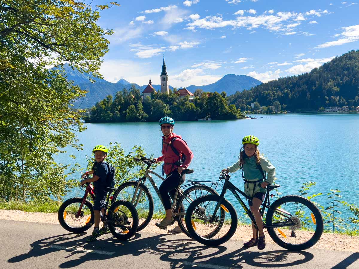 Celine Brewer, of FamilyCanTravel.com, cycles around Lake Bled with her kids.