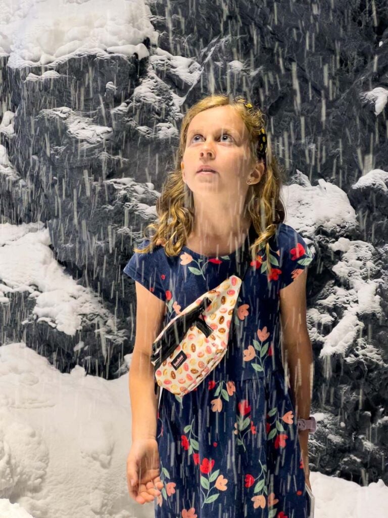 a 10-year old girl is amazed at the indoor falling snow at the Swarovski Crystal Museum just outside Innsbruck, Austria.