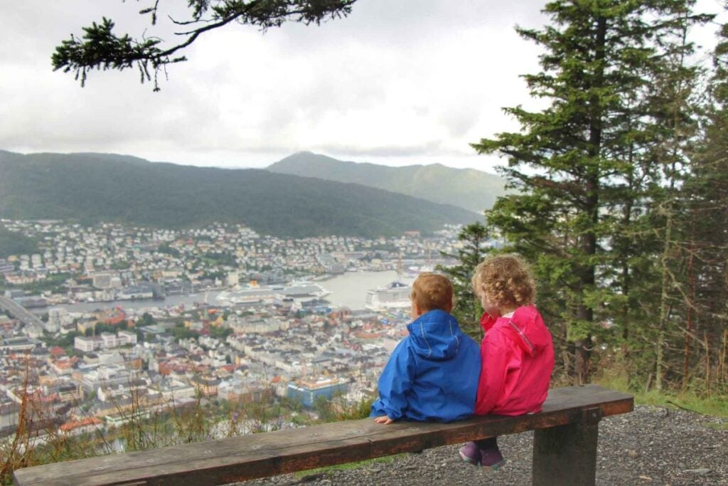 Two young children enjoy the views of Bergen after a family hike up Mt Floyen.