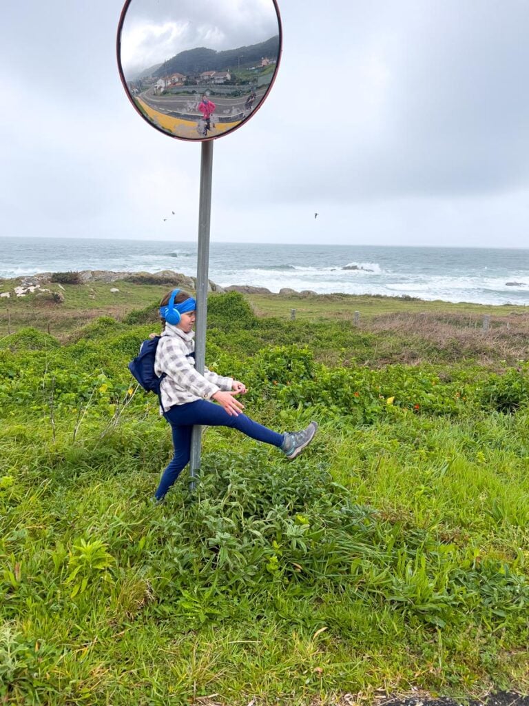 A 10-year old girl makes her family laigh by pretending to walk into a sign post while on the Portuguese Coastal Camino Route.