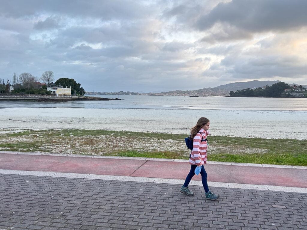 A 10-year old girl walks along the Atlantic Ocean in Baiona, Spain while hiking the Portuguese Camino Coastal route with her family.