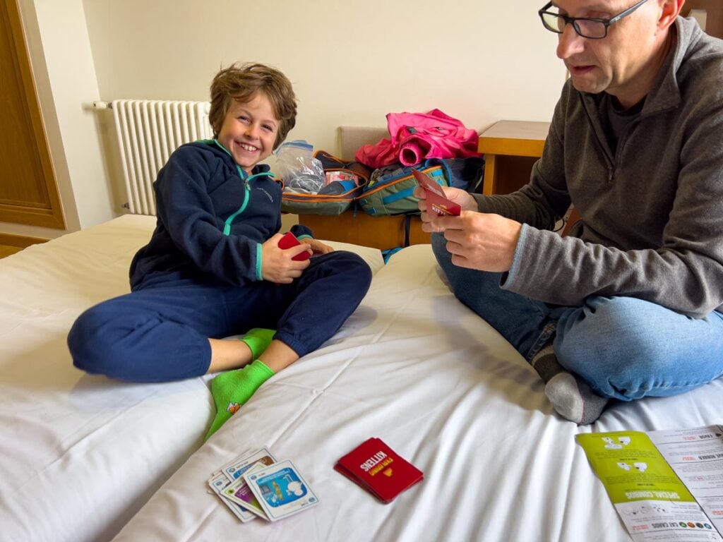 Dan Brewer plays Exploding Kittens with his son while in a hotel room on a family-friendly Camino tour.
