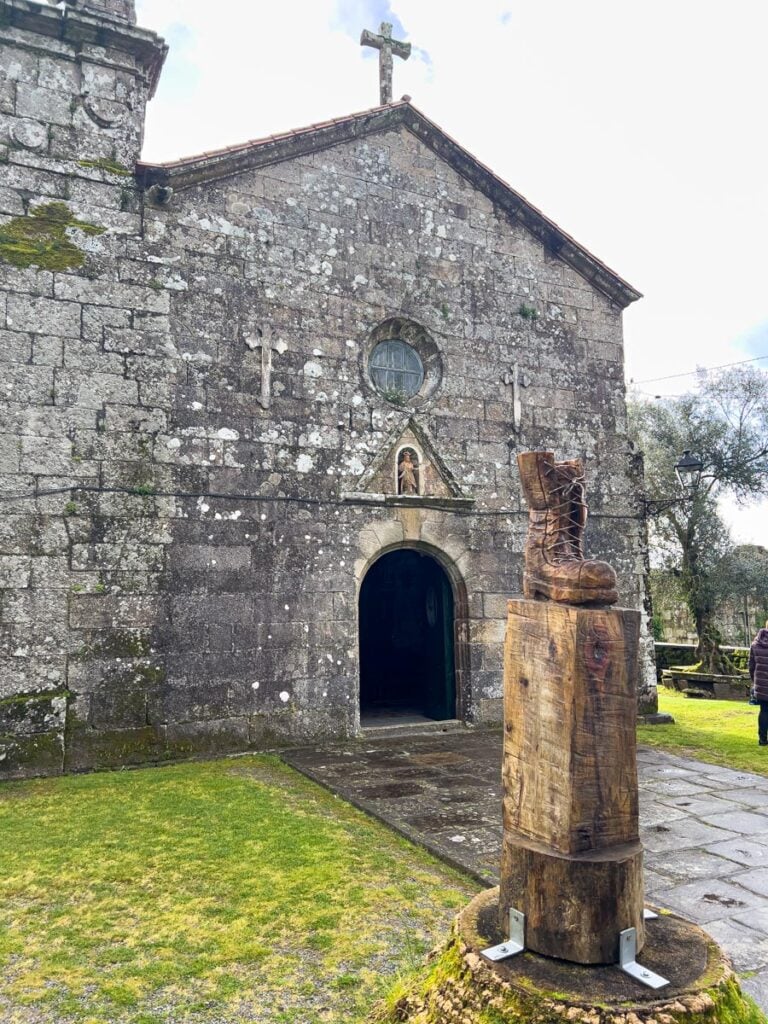A church along the Portuguese Coastal Camino Route has a wooden hiking boot out front.