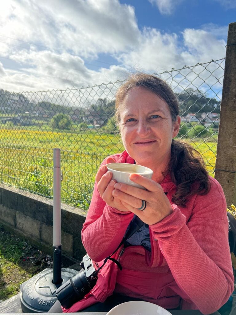 Family travel expert, Celine Brewer, savors a coffee and Santiago cake while hiking the Portuguese Coastal Camino Trail with her family.