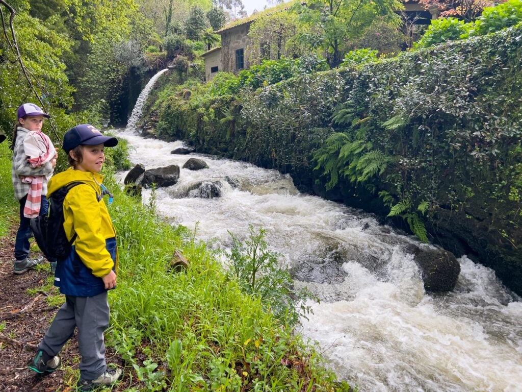 The Brewer kids from FamilyCanTravel.com walk along a river on the final day of the Portuguese Coastal Camino Trail.