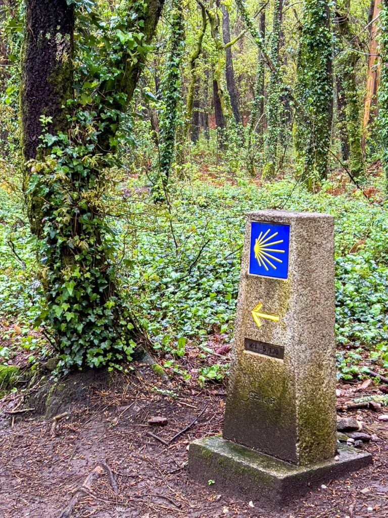 A Portuguese Camino trail marker shows there is only 15 km to go to Santiago de Compostela.
