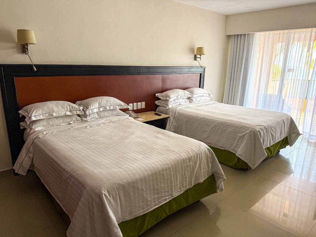 Two Queen beds in a Deluxe Sea Front View Premium Level Room at the Barcelo Huatulco all-inclusive resort.