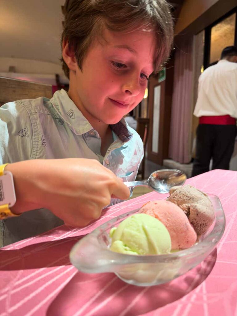 a 9-year old boy enjoys 3 scoops of ice cream after dinner at the Resaurante Agave at the Barcelo Huatulco.