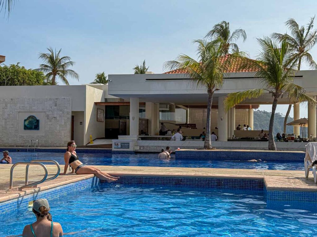 Celine Brewer, owner of FamilyCanTravel.com, relaxes at the swimming pool at a family-friendly all-inclusive resort in Huatulco.