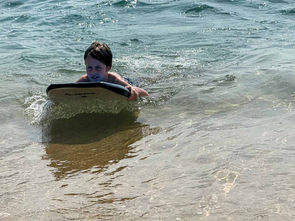 a 9-year old boy enjoys a complimentary boogie board on the beach at the Barcelo Huatulco resort.