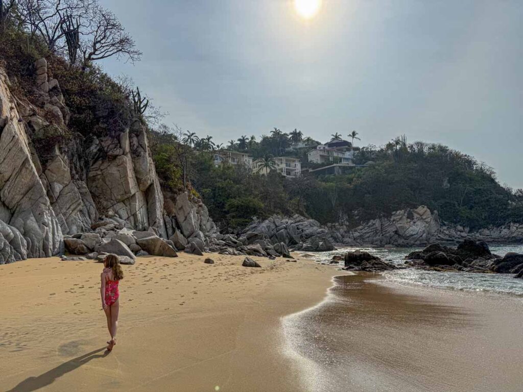 An 11-year old girl walks on the golden sand on Tangolunda Bay during a family vacation in Huatulco, Mexico.