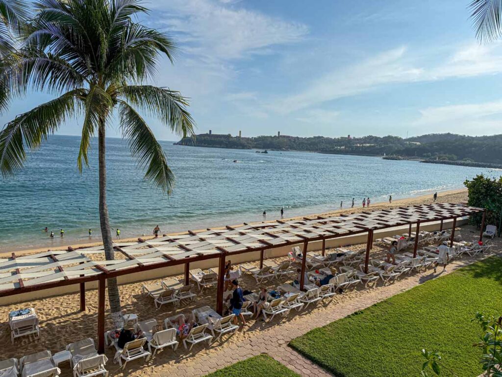 A line of beach chairs face the beautiful ocean views at the Barcelo Huatulco.
