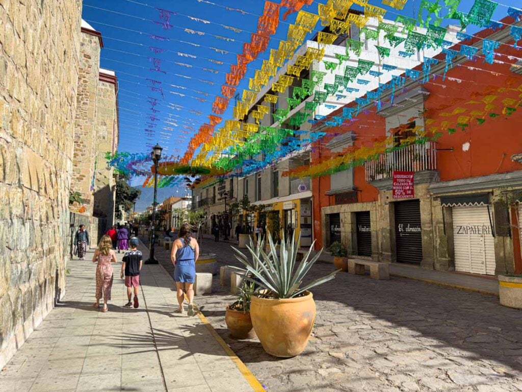 Celine Brewer, owner of FamilyCanTravel.com, walks along Calle Macedonio Alcalá with her kids during a family trip to Oaxaca, Mexico.