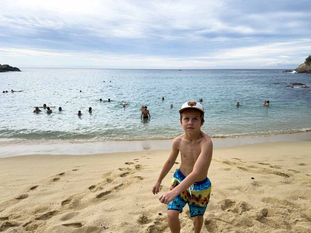 A 9-year old boy plays on teh soft golden sand of Playa Carrizalillo, Puerto Escondido.