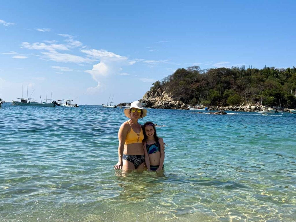 Celine Brewer, owner of FamilyCanTravel.com, enjoys some time in the water at Playa Manzanillo while on a family vacation to Puerto Escondido, Mexico.