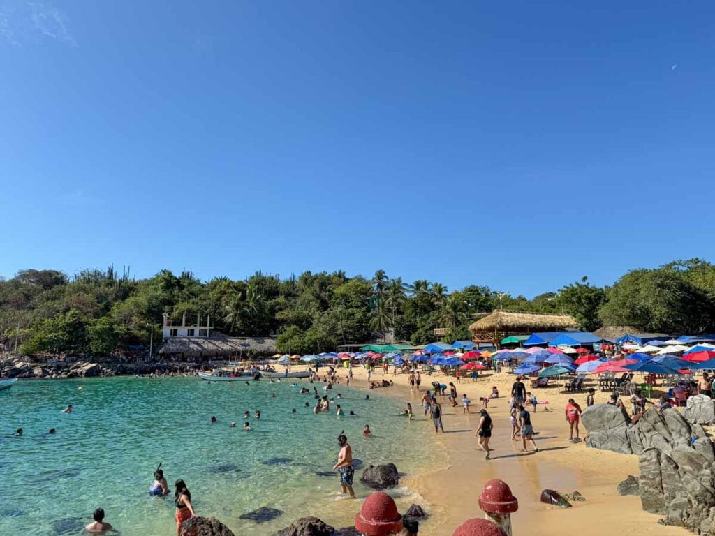 Playa Puerto Angelito is extremely busy during the Christmas holiday season.