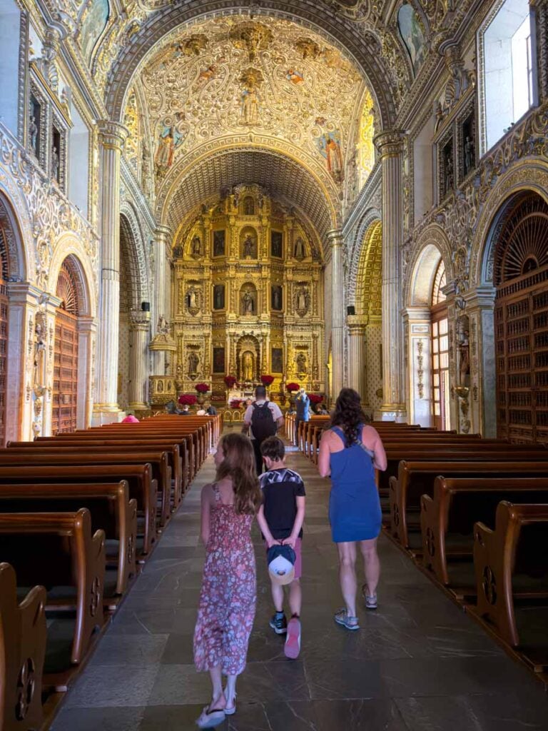 The Brewer family, from FamilyCanTravel.com, admires the beauty of the Templo de Santo Domingo de Guzmán in Oaxaca, Mexico.