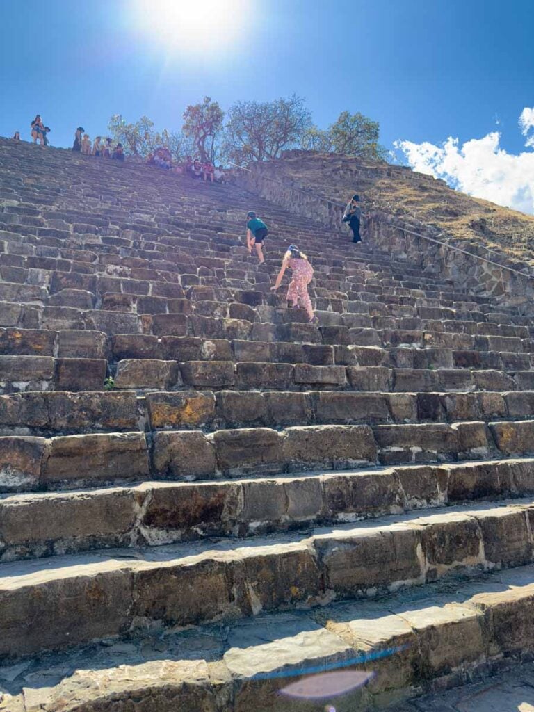 the Brewer kids, from the FamilyCanTravel.com blog, climb some stairs on a ruin at Monte Alban, Oaxaca.