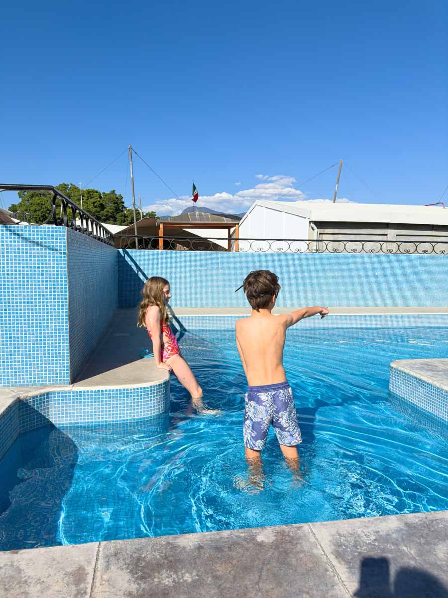 The Brewer kids, from FamilyCanTravel.com, enjoy swimming in the rooftop pool at Suites de la Parra in Oaxaca, Mexico.
