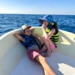 kid-friendly dolphin watching tour Puerto Escondido The Brewer kids from FamilyCanTravel.com, relax at the front of their dolphin watching boat in Puerto Escondido.