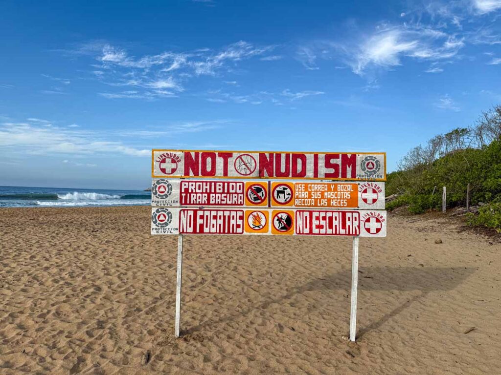 a no nudity sign on the beach in Oaxaca, Mexico.