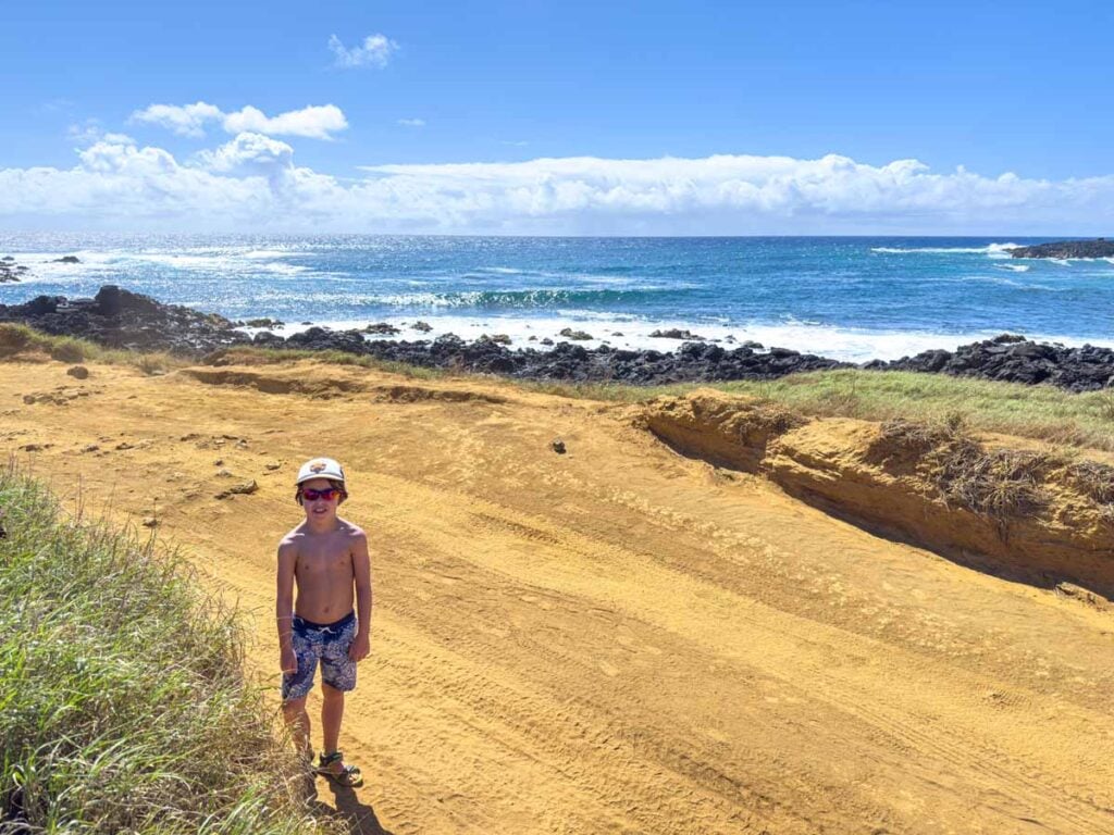 A 9 year old boy enjoys an epic oceanfront hike to Mahana Beach on the Big Island with his family.