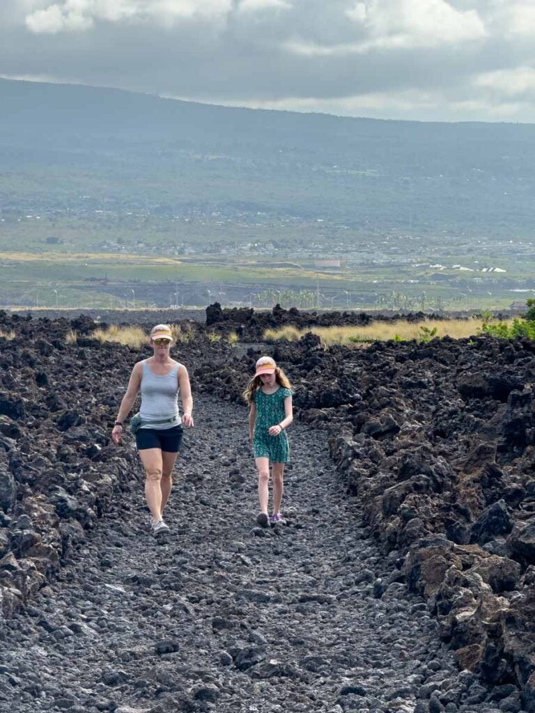Celine Brewer hikes with her daughter through a dried lava field on the Kaloko-Honokohau National Historic Park hike on the Big Island of Hawaii.
