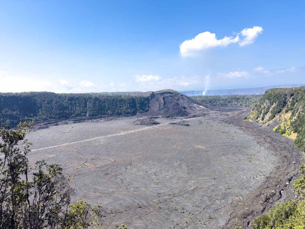 The hiking trail through an old volcano crater is visible from the Crater Rim Trail in Hawaii Volcanoes National Park.