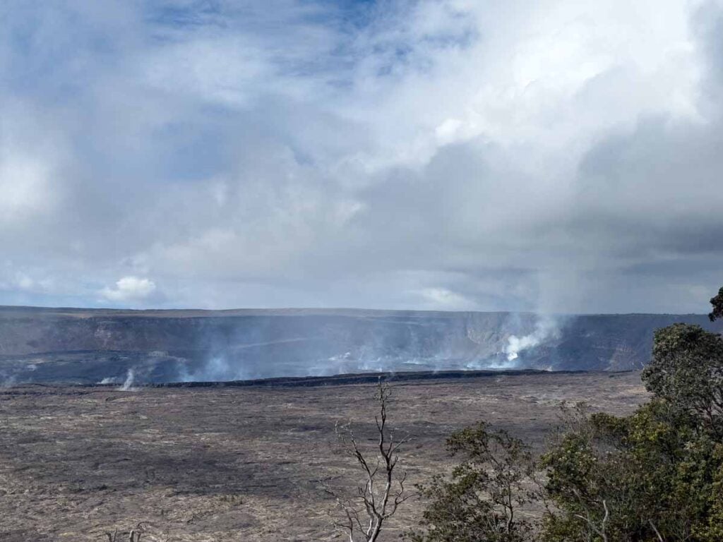 Steam rises from the Kฤซlauea volcano as seen from the western side of the Crater Rim Trail in Hawaii Volcanoes National Park.